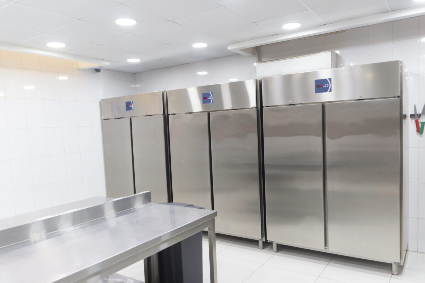 A kitchen with stainless steel refrigerators and counters.