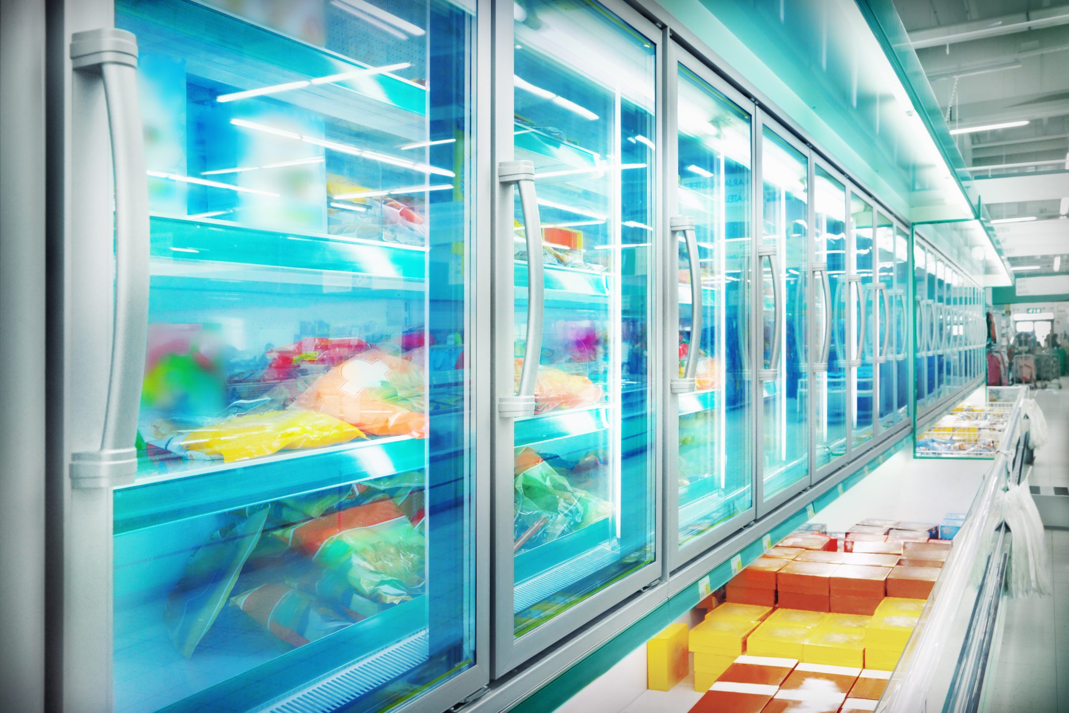 A large freezer with many glass doors and shelves.