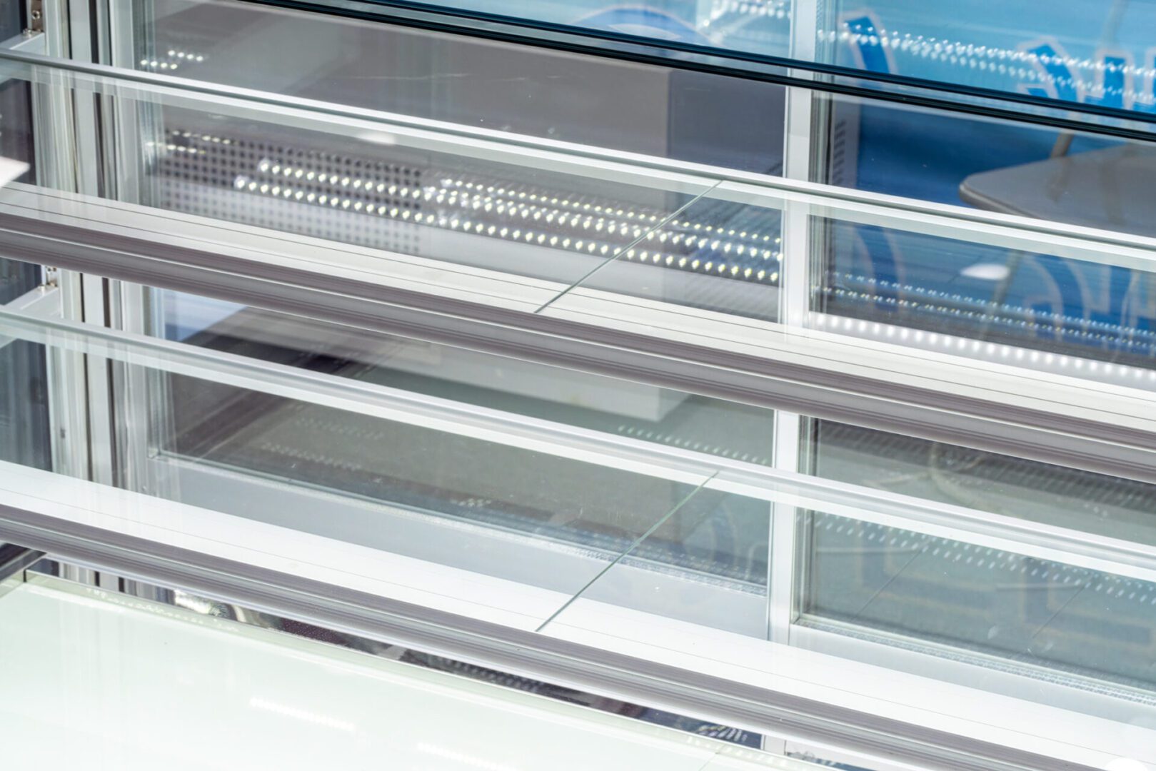 Empty refrigerated cabinet A glass display case with two rows of shelves.
