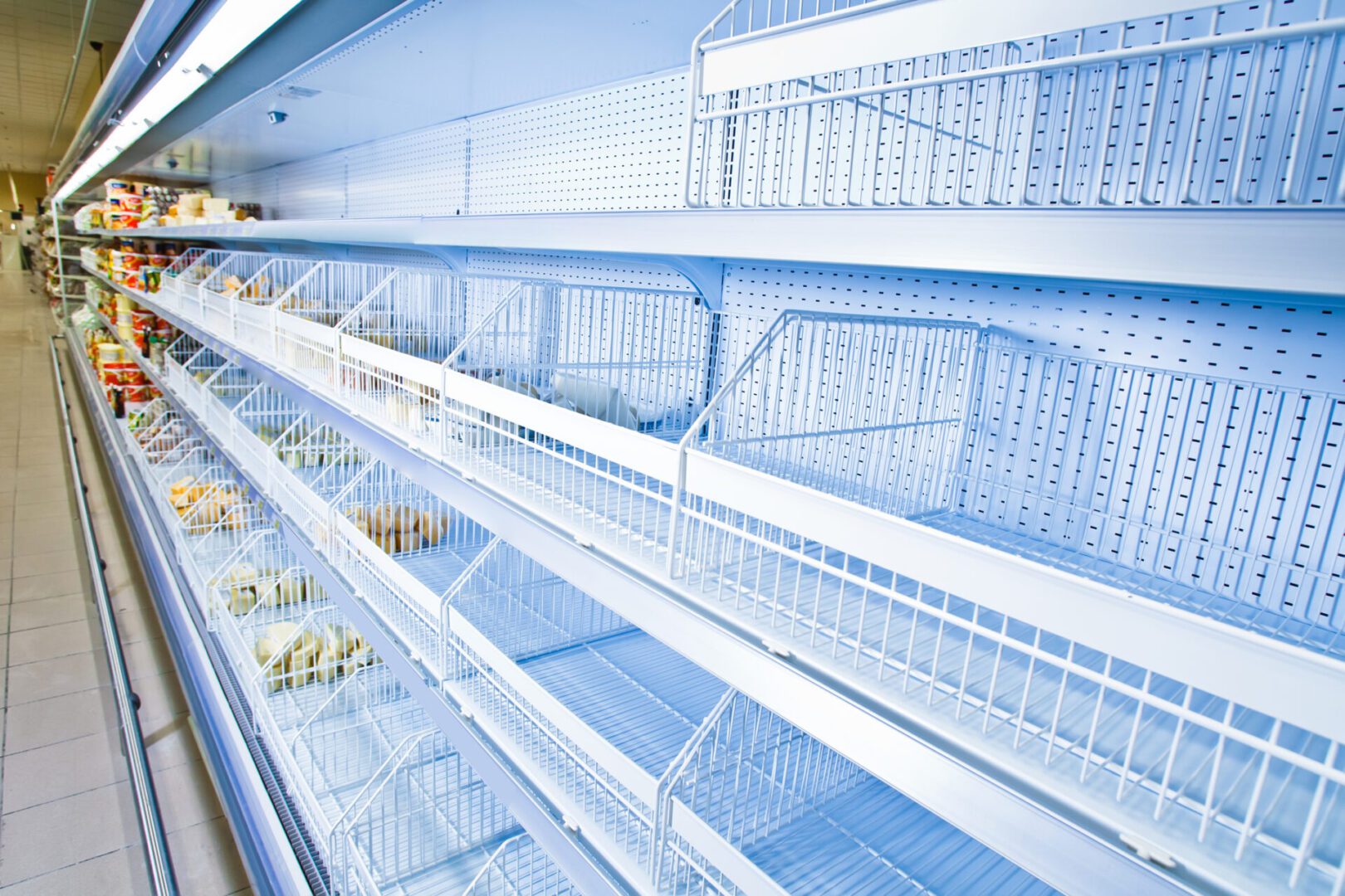 Refrigerated counter. Empty counters. Retail store equipment. Refrigeration chamber for food storage. A large freezer with many shelves of eggs.